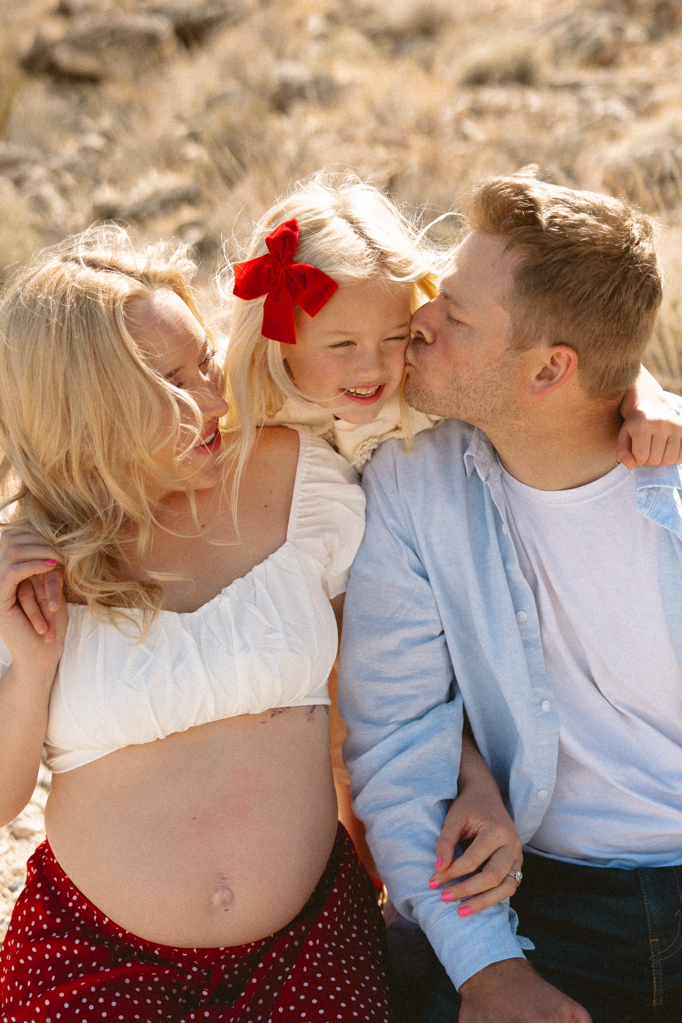 dad kissing daughter on the cheek during a Las Vegas family photographer session