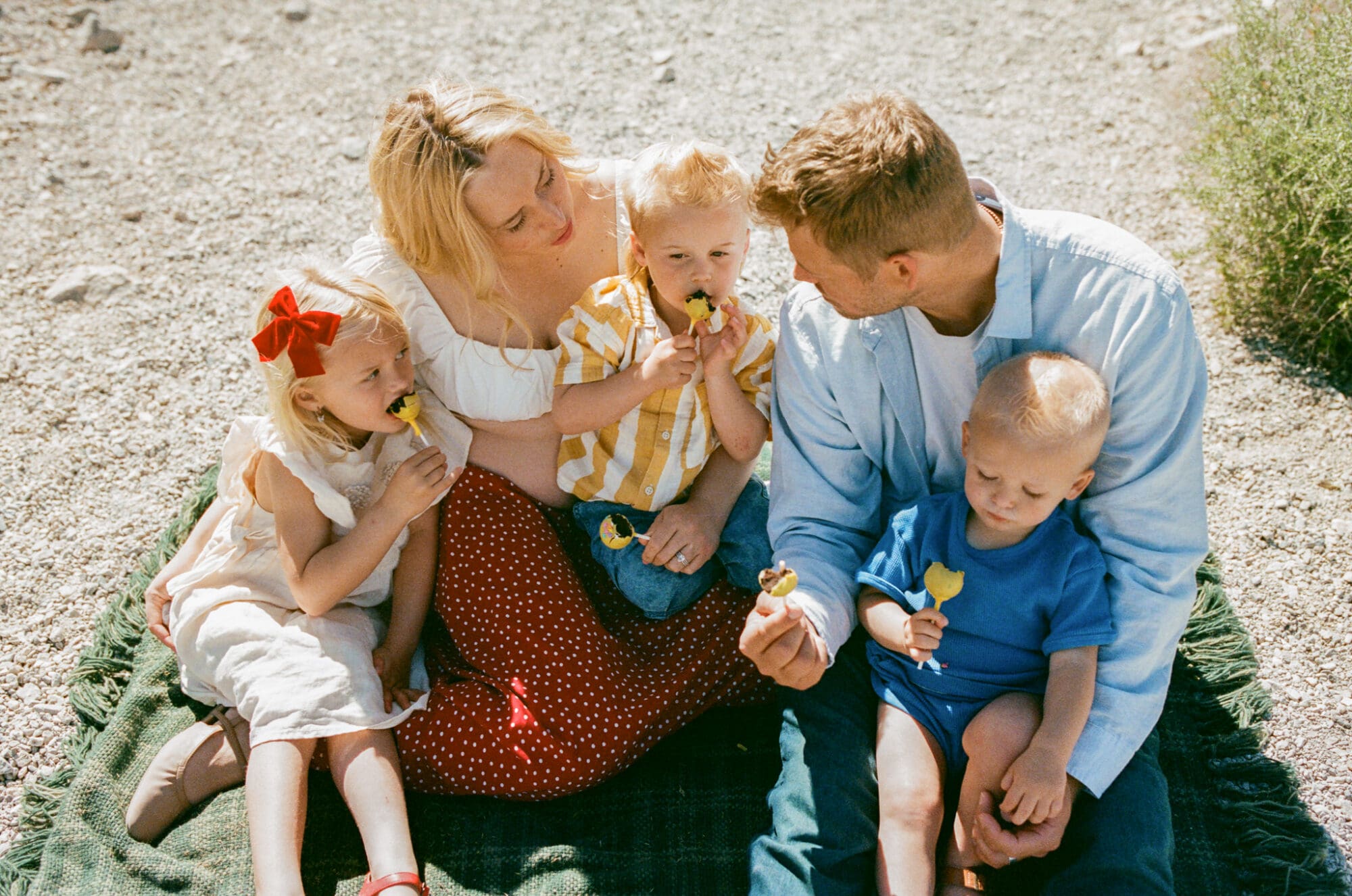 family sitting together on a blanket during a Las Vegas family session on film analog