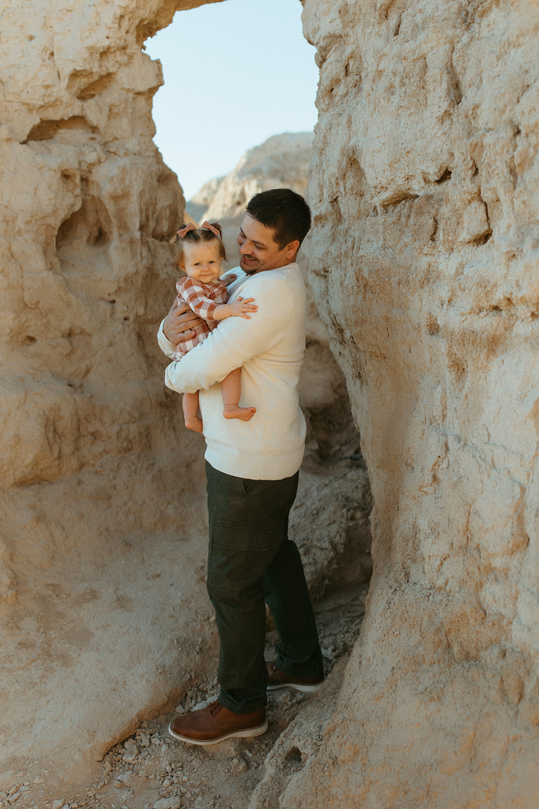 dad with baby girl in a rocky landscape