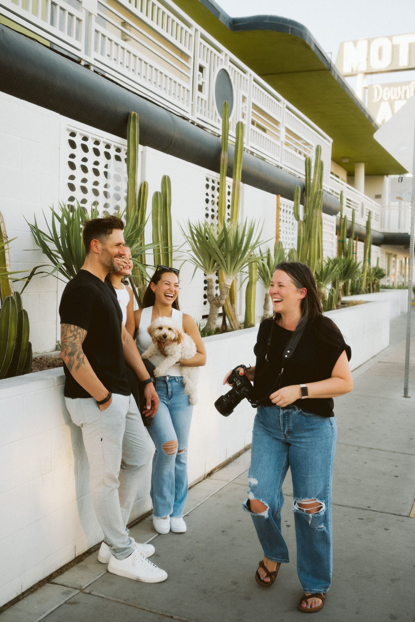 family photographer behind the scenes laughing with clients