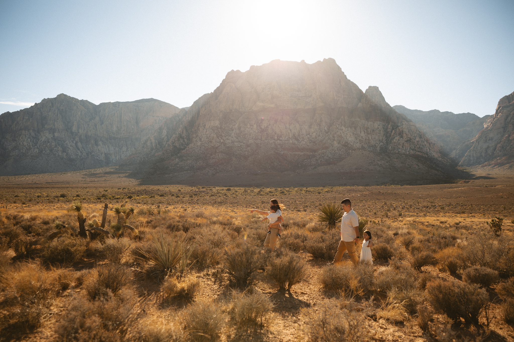 family walking in front of red rock location
